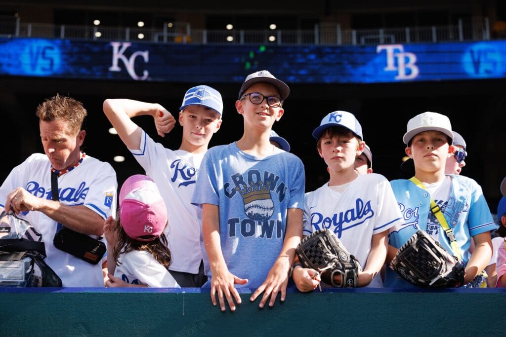 Jun 25, 2025; Kansas City, Missouri, USA; Young fans wait for autographs and the game to start against the Tampa Bay Rays at Kauffman Stadium. Mandatory Credit: William Purnell-Imagn Images