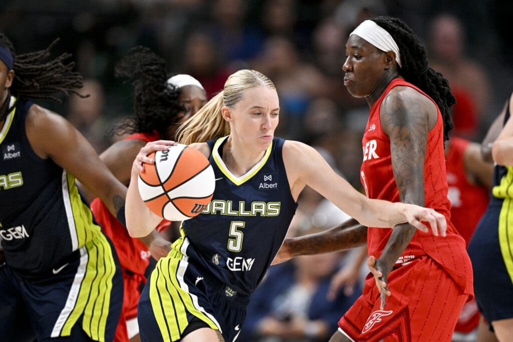 Jun 27, 2025; Dallas, Texas, USA; Dallas Wings guard Paige Bueckers (5) and Indiana Fever forward Natasha Howard (6) in action during the game between the Dallas Wings and the Indiana Fever at the American Airlines Center. Mandatory Credit: Jerome Miron-Imagn Images