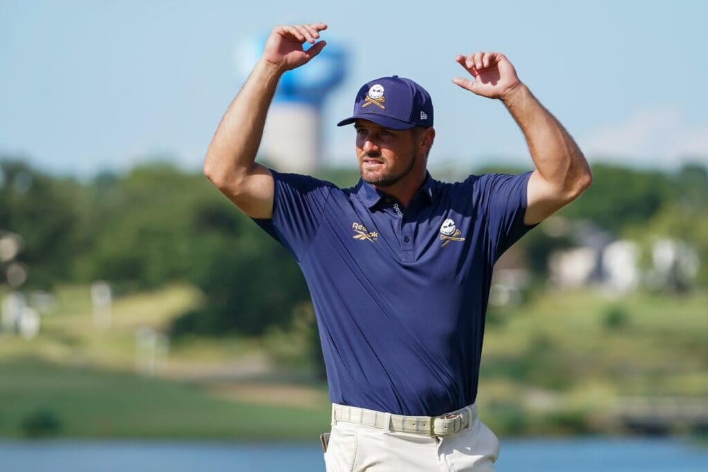 Jun 29, 2025; Carrollton, Texas, USA; Bryson DeChambeau tries to fire up the gallery prior to a four-man playoff during the final round of the LIV Golf Dallas golf tournament at Maridoe Golf Club. Mandatory Credit: Raymond Carlin III-Imagn Images