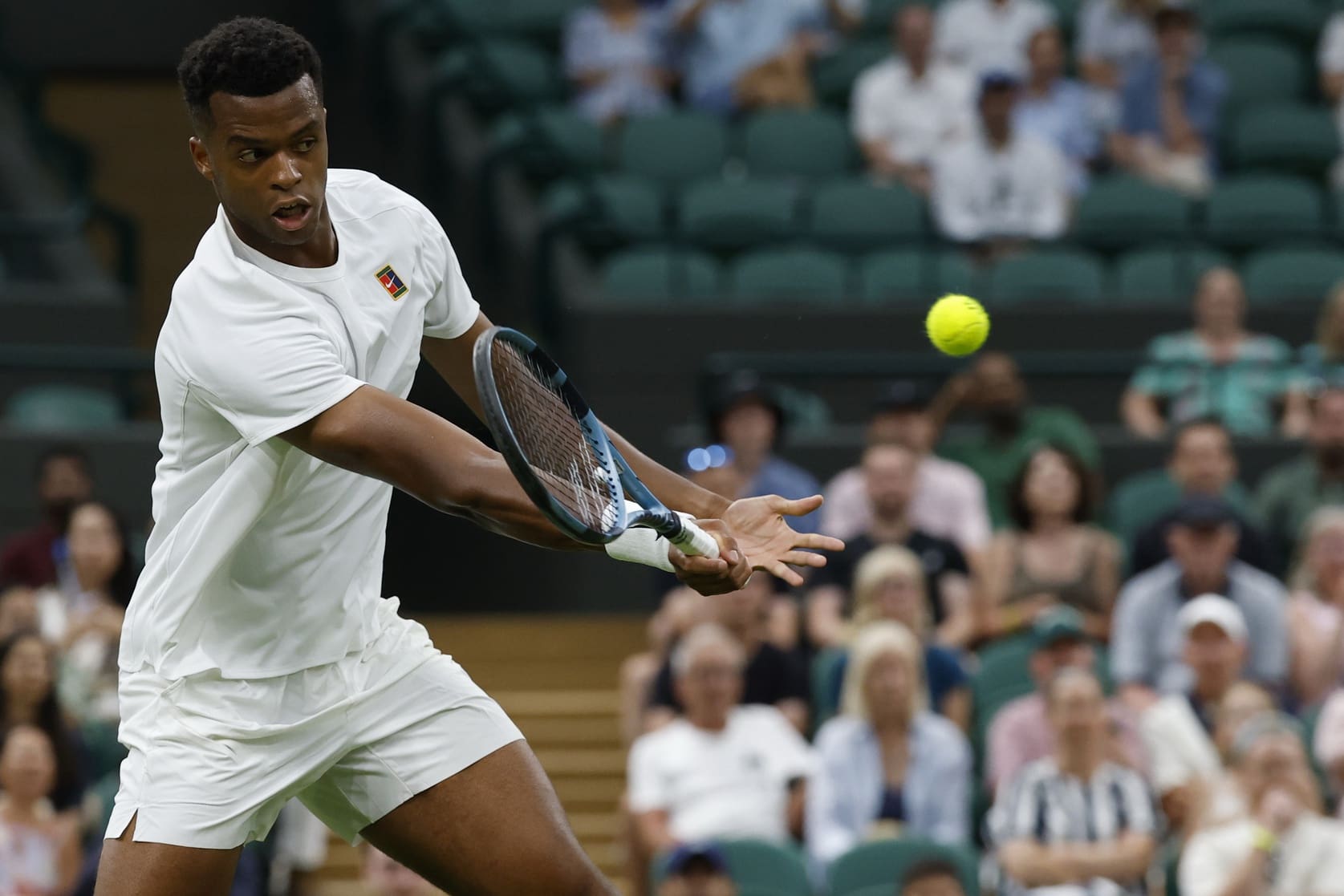 Jun 30, 2025; Wimbledon, United Kingdom; Giovanni Mpetshi Perricard (FRA) hits a volley against Taylor Fritz (USA)(not pictured) on day one of The Championships, Wimbledon 2025 at All England Lawn Tennis and Croquet Club. Mandatory Credit: Geoff Burke-Imagn Images