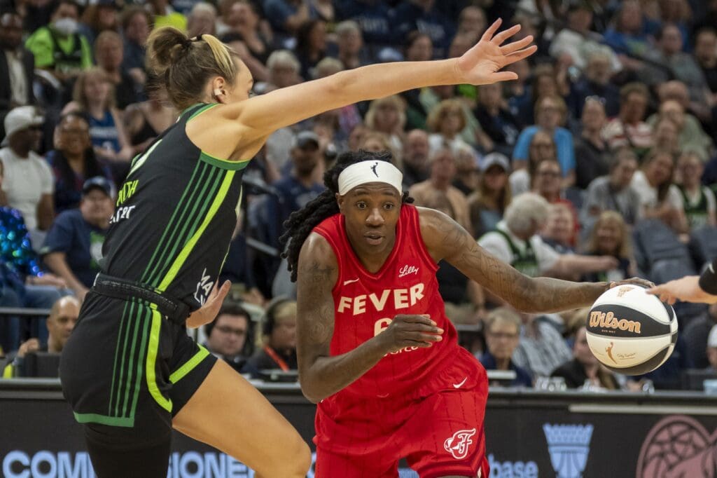 Jul 1, 2025; Minneapolis, Minnesota, USA; Indiana Fever forward Natasha Howard (6) drives to the basket past Minnesota Lynx forward Alanna Smith (8) in the first half during the Commissioner's Cup final at Target Center. Mandatory Credit: Jesse Johnson-Imagn Images