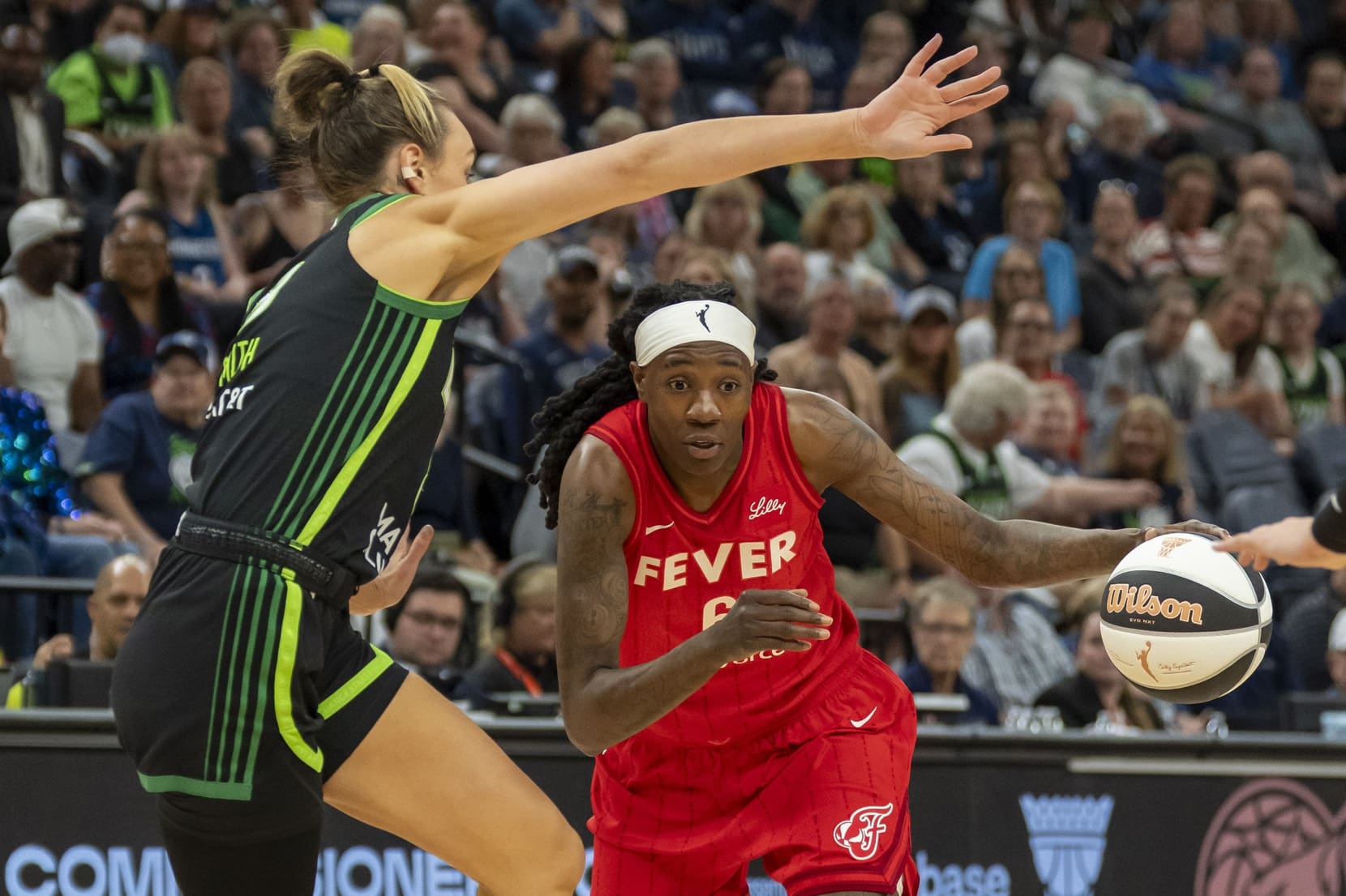 Jul 1, 2025; Minneapolis, Minnesota, USA; Indiana Fever forward Natasha Howard (6) drives to the basket past Minnesota Lynx forward Alanna Smith (8) in the first half during the Commissioner's Cup final at Target Center. Mandatory Credit: Jesse Johnson-Imagn Images