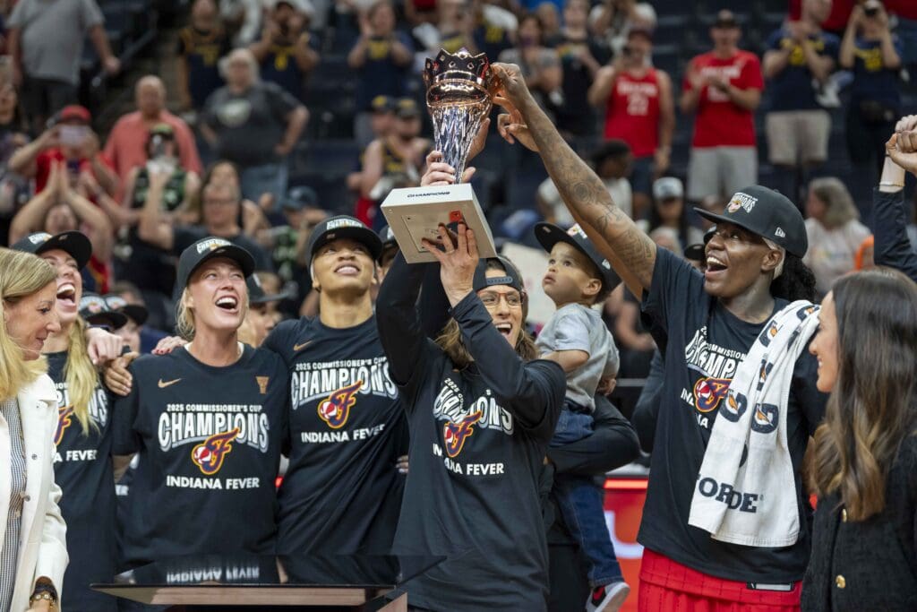 Jul 1, 2025; Minneapolis, Minnesota, USA; Indiana Fever head coach Stephanie White holds up the Commissioner's Cup trophy with Indiana Fever forward Natasha Howard (6) after defeating the Minnesota Lynx at Target Center. Mandatory Credit: Jesse Johnson-Imagn Images
