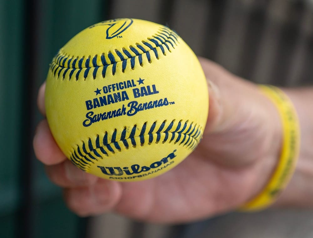 Umpire Eric Goldstein of Worcester holds a ball from the Savannah Bananas.