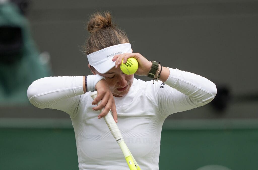 Jul 5, 2025; Wimbledon, United Kingdom; Barbora Krejcikova of the Czech Republic wipes away tears during her match against Emma Navarro of the United States on day six at the All England Lawn Tennis and Croquet Club. Mandatory Credit: Susan Mullane-Imagn Images