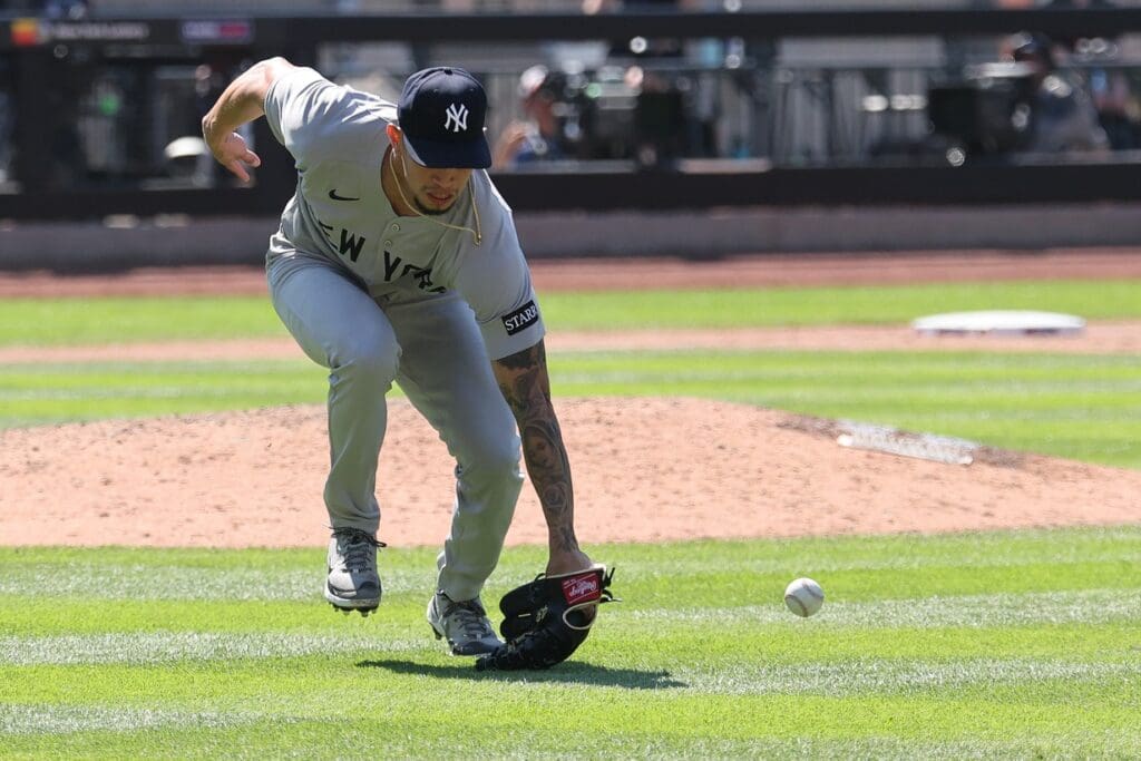 Jul 6, 2025; New York City, New York, USA; New York Yankees relief pitcher Jonathan Loaisiga (43) can not field a ball hit by New York Mets pinch hitter Jeff McNeil (not pictured) during the sixth inning at Citi Field. Mandatory Credit: Vincent Carchietta-Imagn Images