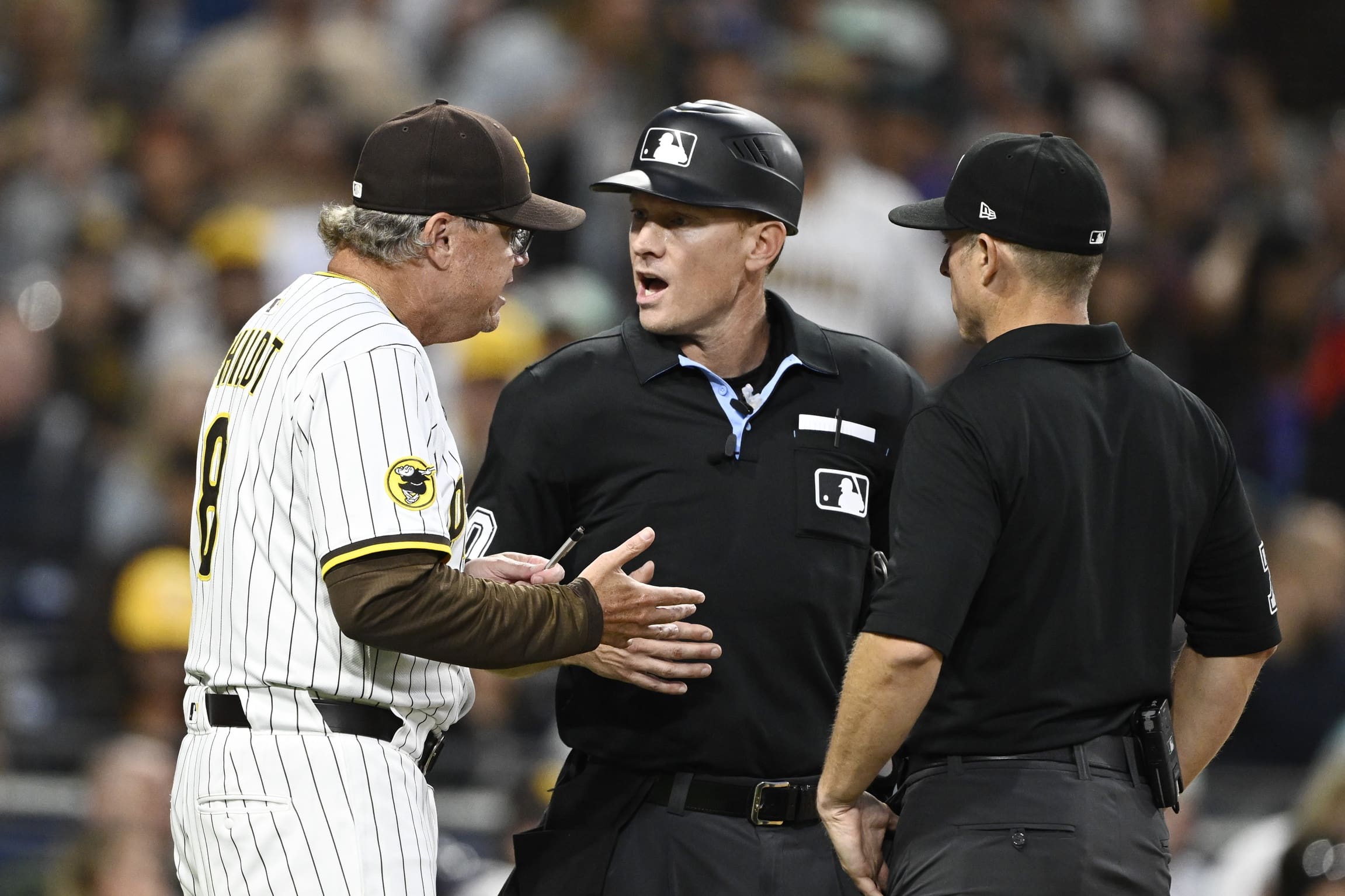 Jul 8, 2025; San Diego, California, USA; San Diego Padres manager Mike Shildt (8) argues a call with umpires Brian Walsh (60), center, and Tripp Gibson during the sixth inning against the Arizona Diamondbacks at Petco Park. Mandatory Credit: Denis Poroy-Imagn Images