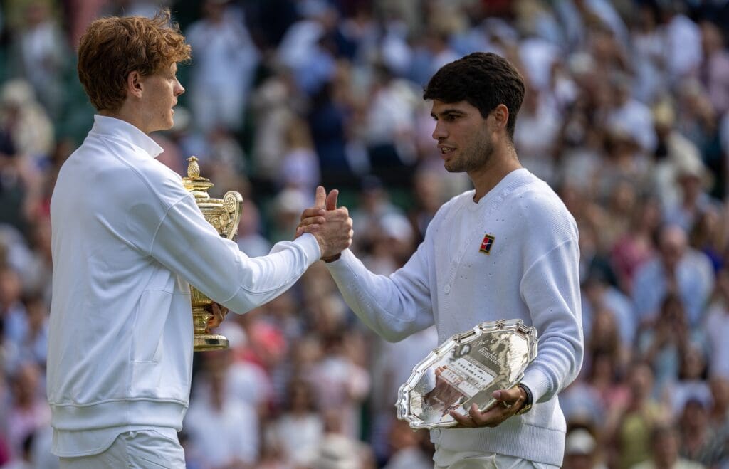 Jul 13, 2025; Wimbledon, United Kingdom; Carlos Alcaraz of Spain and Jannik Sinner of Italy pose with their trophies after the menÕs singles final on day 14 at All England Lawn Tennis and Croquet Club. Mandatory Credit: Susan Mullane-Imagn Images