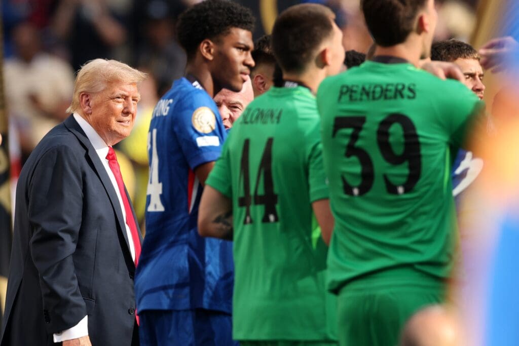 Jul 13, 2025; East Rutherford, New Jersey, USA; U.S. President Donald Trump reacts on stage during the final of the 2025 FIFA Club World Cup at MetLife Stadium. Mandatory Credit: Vincent Carchietta-Imagn Images