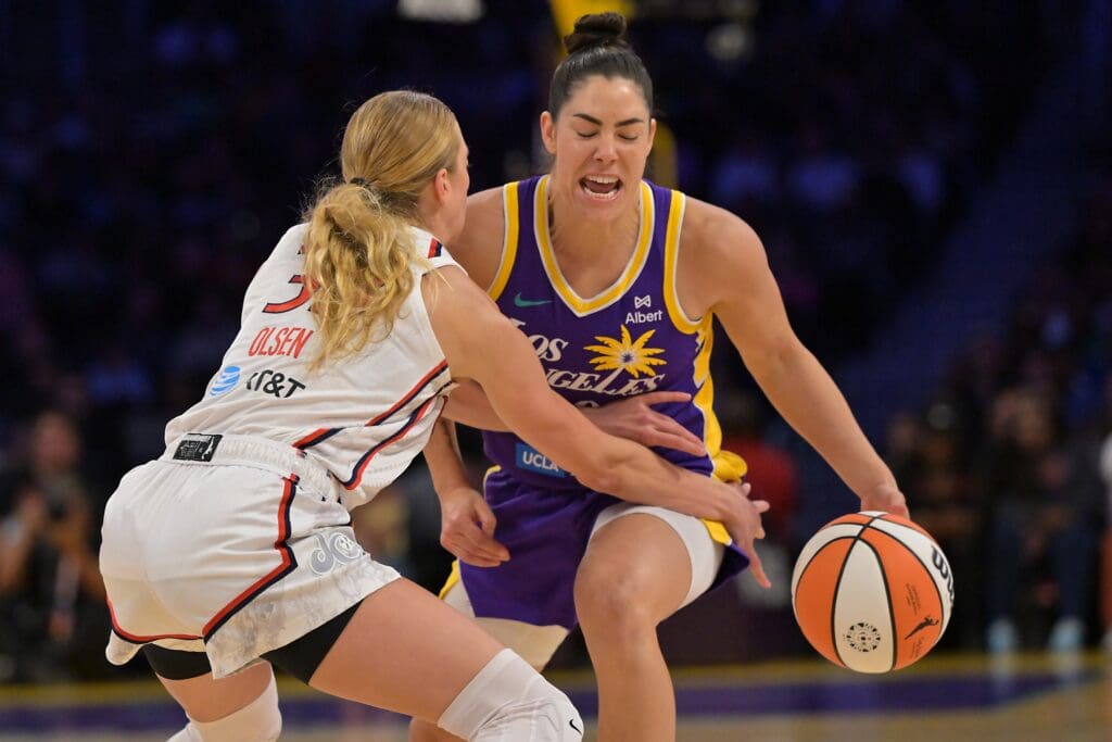 Jul 15, 2025; Los Angeles, California, USA; Los Angeles Sparks guard Kelsey Plum (10) is fouled by Washington Mystics guard Lucy Olsen (33) during the first half at Crypto.com Arena. Mandatory Credit: Jayne Kamin-Oncea-Imagn Images