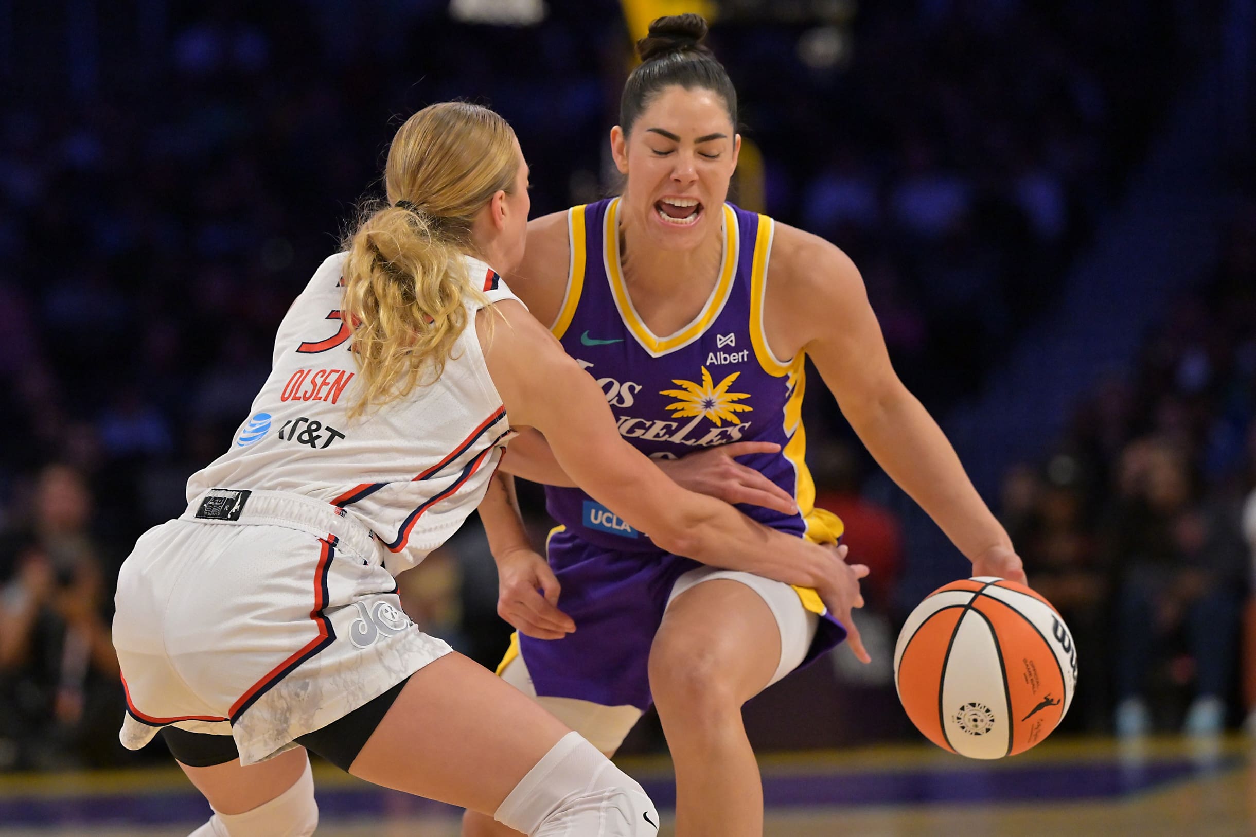 Jul 15, 2025; Los Angeles, California, USA; Los Angeles Sparks guard Kelsey Plum (10) is fouled by Washington Mystics guard Lucy Olsen (33) during the first half at Crypto.com Arena. Mandatory Credit: Jayne Kamin-Oncea-Imagn Images