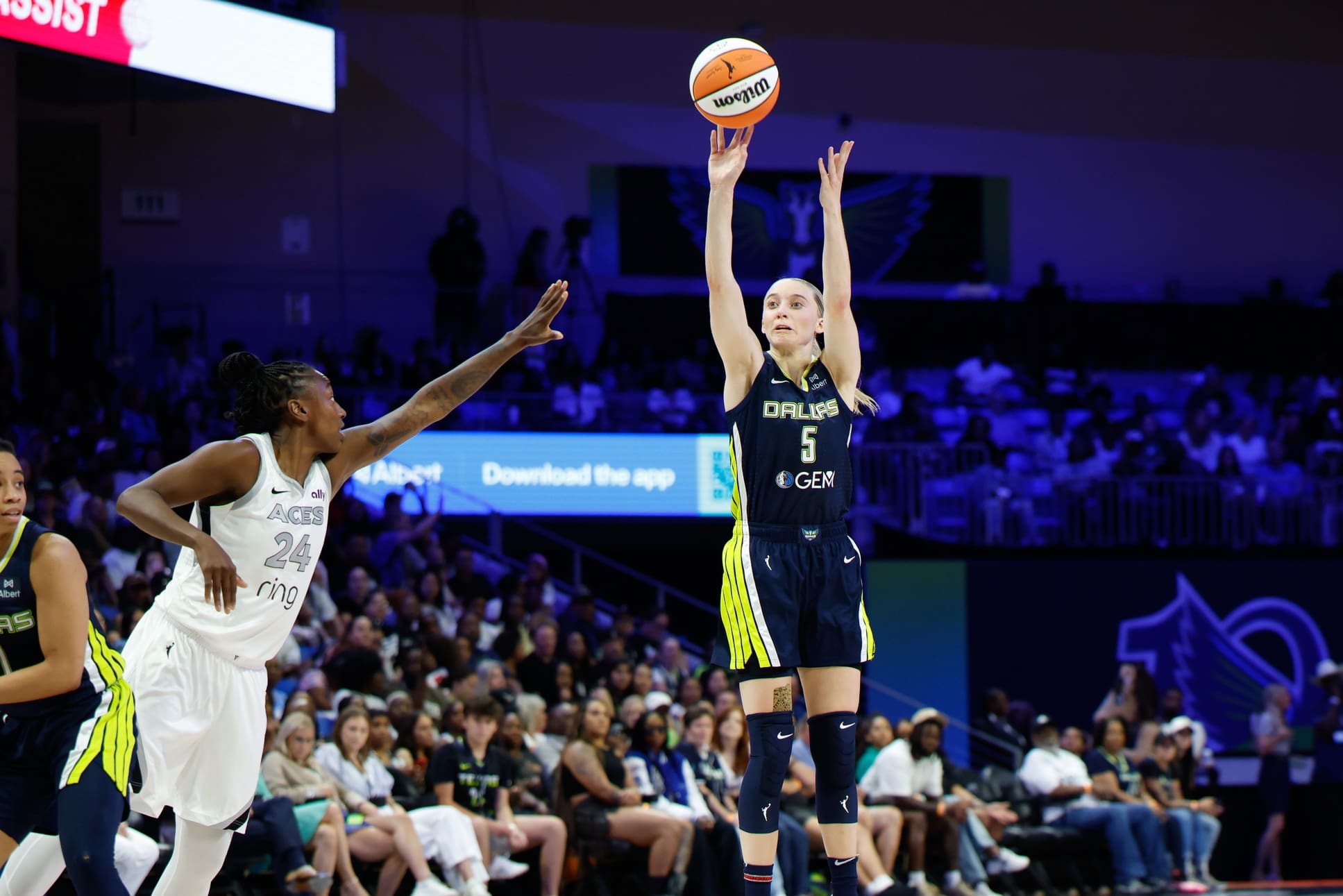 Jul 16, 2025; Arlington, Texas, USA; Dallas Wings guard Paige Bueckers (5) scores a three-point basket against Las Vegas Aces guard Jewell Loyd (24) during the second half at College Park Center. Mandatory Credit: Chris Jones-Imagn Images