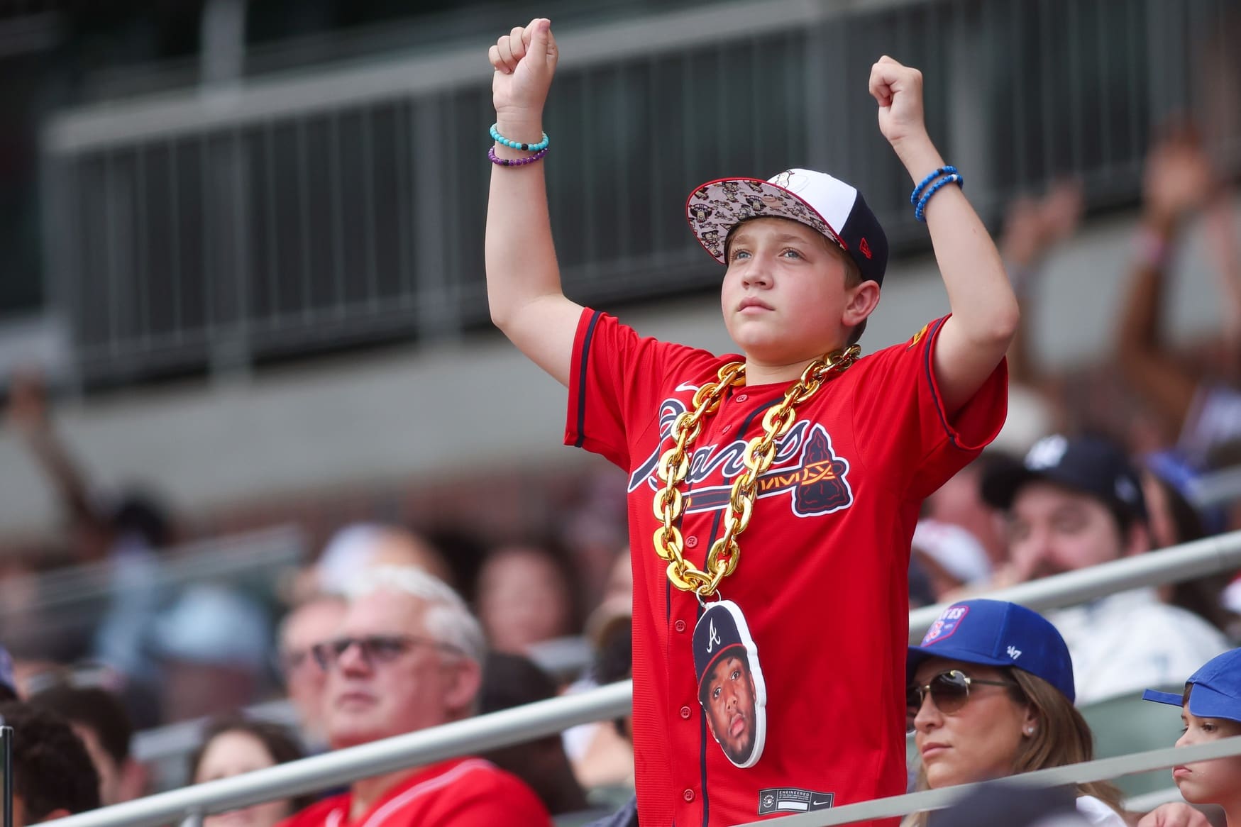 Jul 19, 2025; Atlanta, Georgia, USA; Atlanta Braves fan cheers in the stands against the New York Yankees in the second inning at Truist Park. Mandatory Credit: Brett Davis-Imagn Images