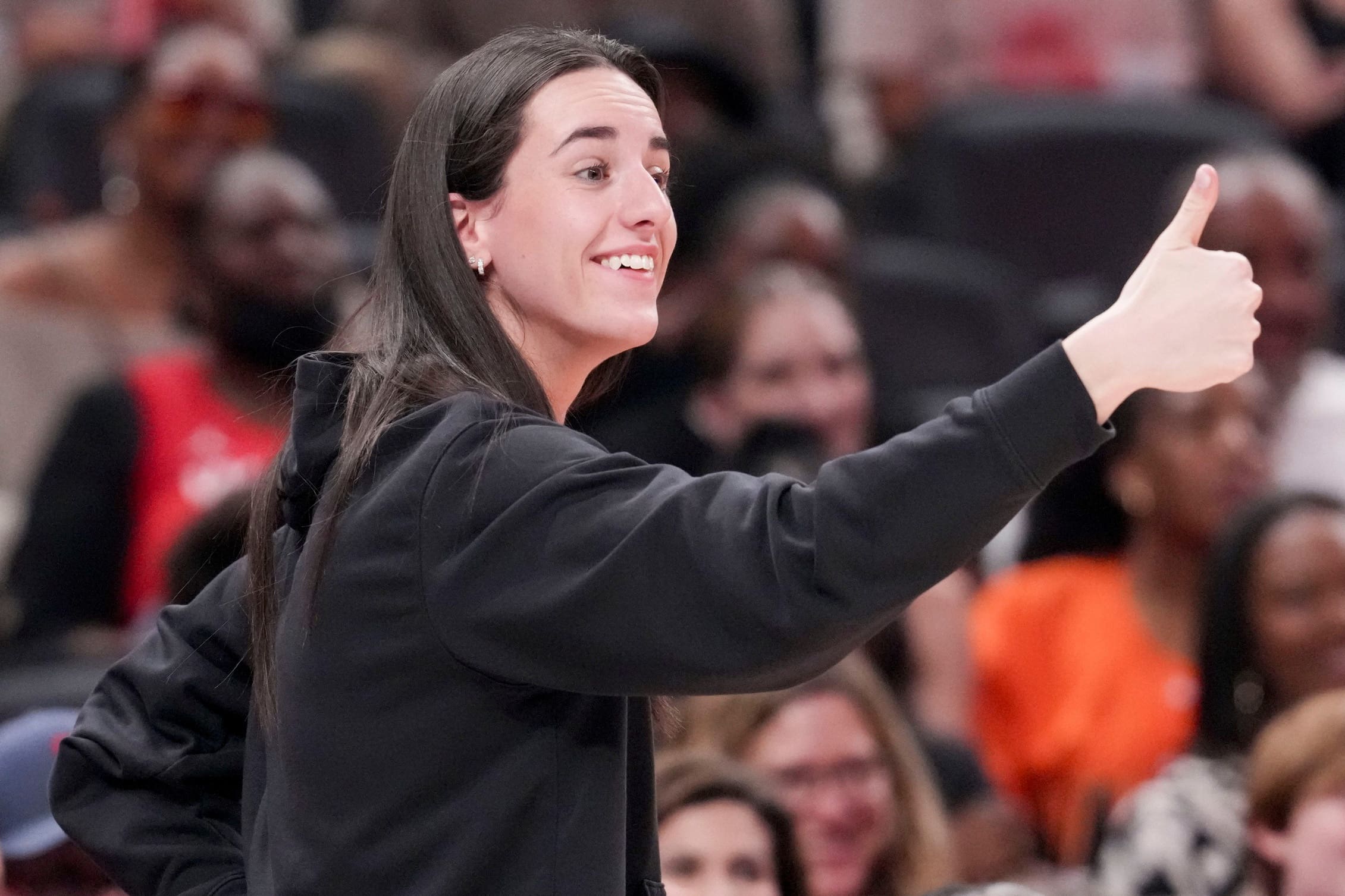 Indiana Fever's Caitlin Clark (22) gives a thumbs up to Los Angeles Sparks's Kelsey Plum (10) after she travels with the ball Saturday, July 19, 2025, during the WNBA All-Star Game at Gainbridge Fieldhouse in Indianapolis.