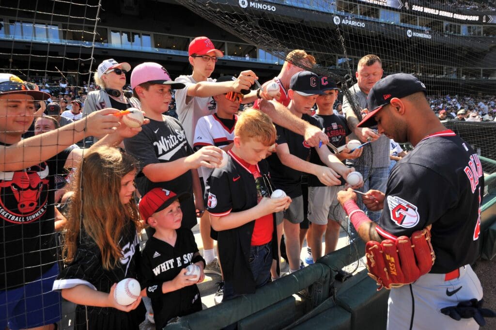 Jul 12, 2025; Chicago, Illinois, USA; Cleveland Guardians shortstop Brayan Rocchio (4) signs autographs for fans prior to a game against the Chicago White Sox at Rate Field. Mandatory Credit: Patrick Gorski-Imagn Images