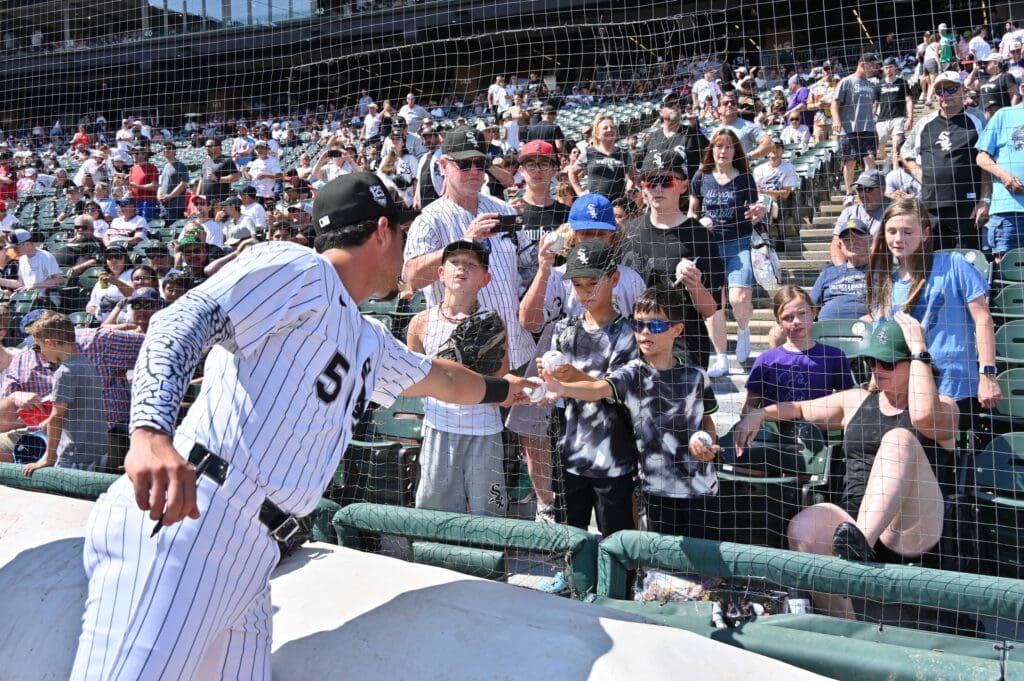 Jul 12, 2025; Chicago, Illinois, USA; Chicago White Sox third baseman Josh Rojas (5) signs autographs for fans prior to a game against the Cleveland Guardians at Rate Field. Mandatory Credit: Patrick Gorski-Imagn Images
