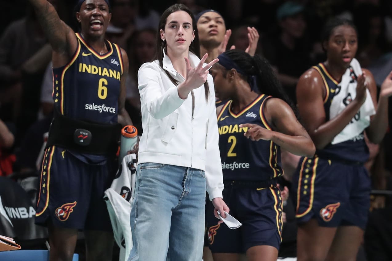 Jul 22, 2025; Brooklyn, New York, USA; Indiana Fever guard Caitlin Clark (not in uniform) celebrates from the bench in the first quarter against the New York Liberty at Barclays Center. Mandatory Credit: Wendell Cruz-Imagn Images