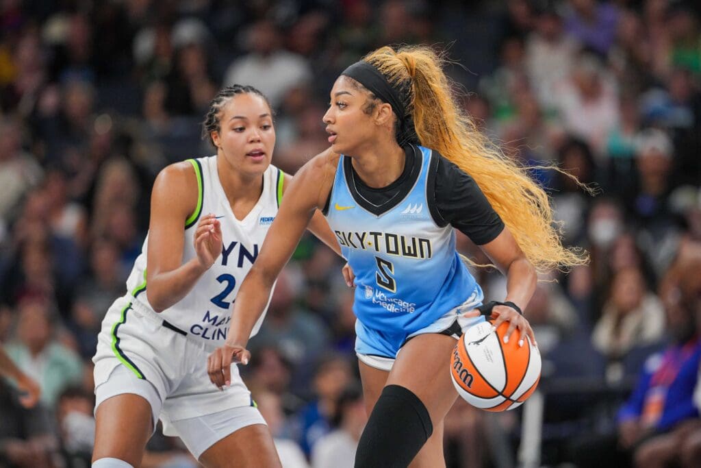 Jul 22, 2025; Minneapolis, Minnesota, USA; Chicago Sky forward Angel Reese (5) dribbles against the Minnesota Lynx forward Napheesa Collier (24) in the fourth quarter at Target Center. Mandatory Credit: Brad Rempel-Imagn Images