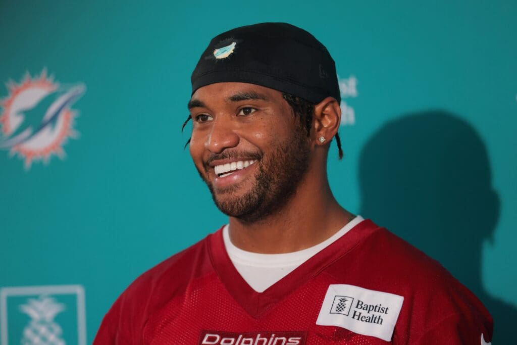 Jul 23, 2025; Miami Gardens, FL, USA; Miami Dolphins quarterback Tua Tagovailoa (1) speaks to reporters during training camp at Baptist Health Training Complex. Mandatory Credit: Sam Navarro-Imagn Images