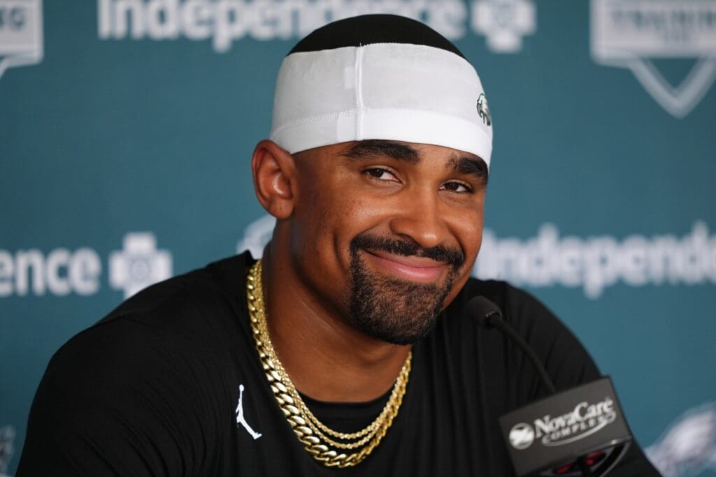 Jul 23, 2025; Philadelphia, PA, USA; Philadelphia Eagles quarterback Jalen Hurts (1) reacts as he addresses media during training camp at NovaCare Complex. Mandatory Credit: Kyle Ross-Imagn Images