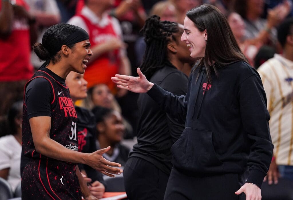 Indiana Fever guard Caitlin Clark (22) high-fives Indiana Fever guard Sydney Colson (51) on Thursday, July 24, 2025, during the game at Gainbridge Fieldhouse in Indianapolis.
