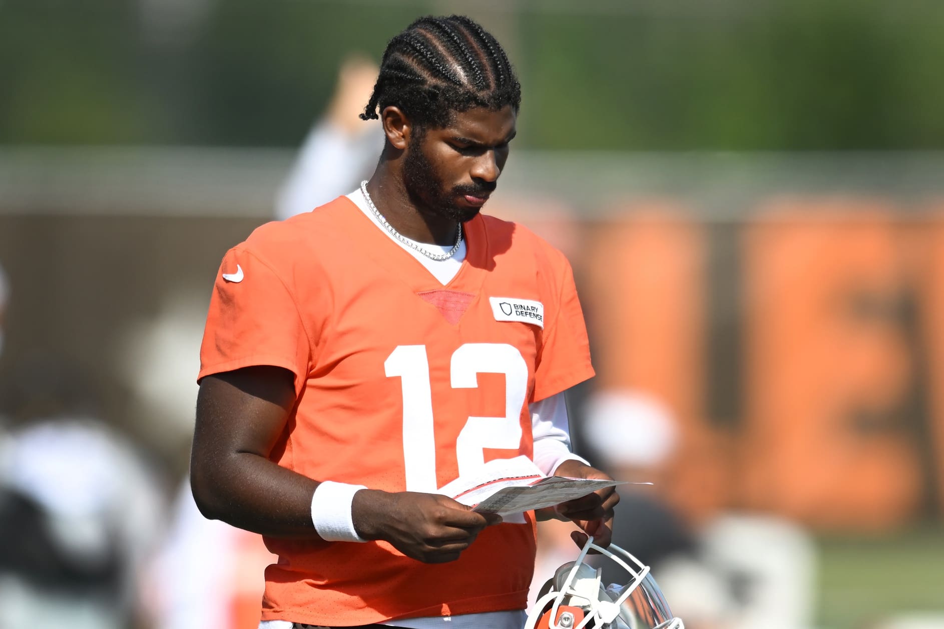 Jul 26, 2025; Berea, OH, USA; Cleveland Browns quarterback Shedeur Sanders (12) looks at a play sheet during training camp at CrossCountry Mortgage Campus. Mandatory Credit: Ken Blaze-Imagn Images