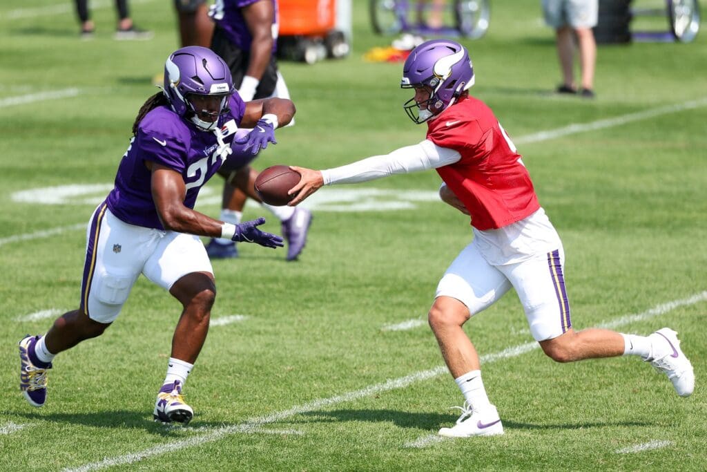 Jul 28, 2025; Eagan, MN, USA; Minnesota Vikings quarterback J.J. McCarthy (9) hands the ball off to running back Jordan Mason (27) during the teams training camp at the Minnesota Vikings Training Facility.