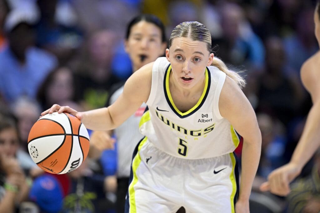 Jul 28, 2025; Arlington, Texas, USA; Dallas Wings guard Paige Bueckers (5) looks to move the ball to the basket against the New York Liberty during the first half at College Park Center. Mandatory Credit: Jerome Miron-Imagn Images