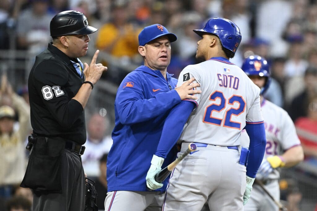 Jul 28, 2025; San Diego, California, USA; New York Mets right fielder Juan Soto (22) argues with umpire Emil Jimenez (82) as manager Carlos Mendoza (64) holds him back after a called strike out during the third inning against the San Diego Padres at Petco Park. Mandatory Credit: