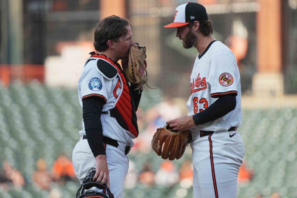 Jul 29, 2025; Baltimore, Maryland, USA; Baltimore Orioles pitcher Brandon Young (63) talks with catcher Adley Rutschman (35) during the first inning against the Toronto Blue Jays at Oriole Park at Camden Yards. Mandatory Credit: Mitch Stringer-Imagn Images