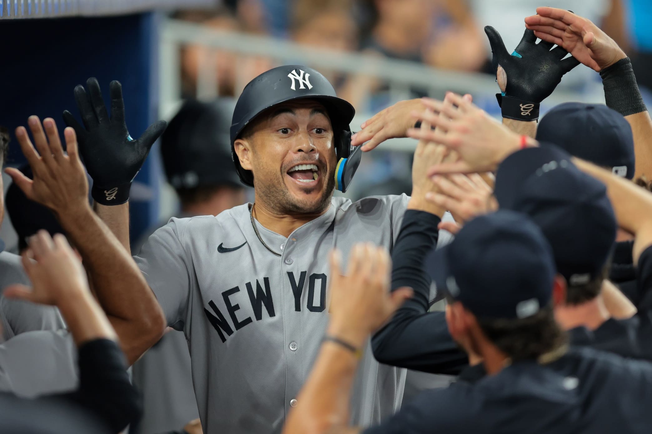 Aug 1, 2025; Miami, Florida, USA; New York Yankees designated hitter Giancarlo Stanton (27) celebrates with teammates after hitting a three-run home run against the Miami Marlins during the fourth inning at loanDepot Park. Mandatory Credit: Sam Navarro-Imagn Images