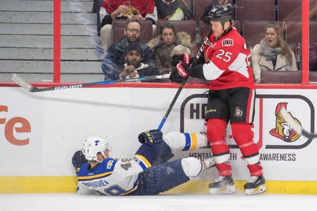 Feb 7, 2017; Ottawa, Ontario, CAN; St. Louis Blues center Ivan Barbashev (49) is checked by Ottawa Senators right wing Chris Neil (25) in the second period at the Canadian Tire Centre. Mandatory Credit: Marc DesRosiers-USA TODAY Sports