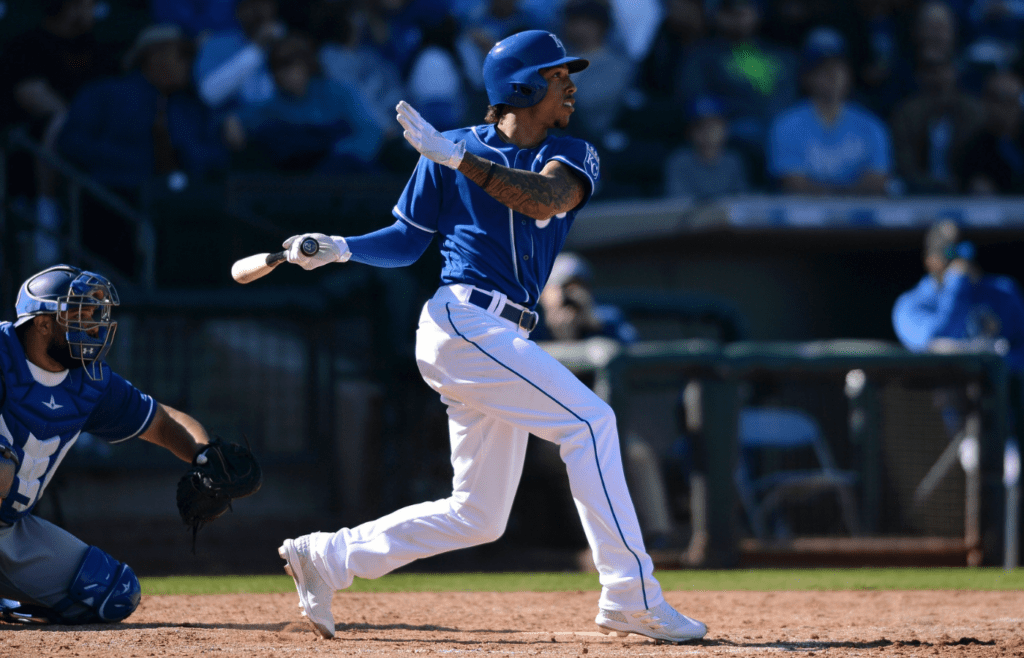 Feb 24, 2018; Surprise, AZ, USA; Kansas City Royals second baseman Raul Mondesi (27) watches his solo home run during the sixth inning against the Los Angeles Dodgers at Surprise Stadium. Mandatory Credit: Orlando Ramirez-Imagn Images