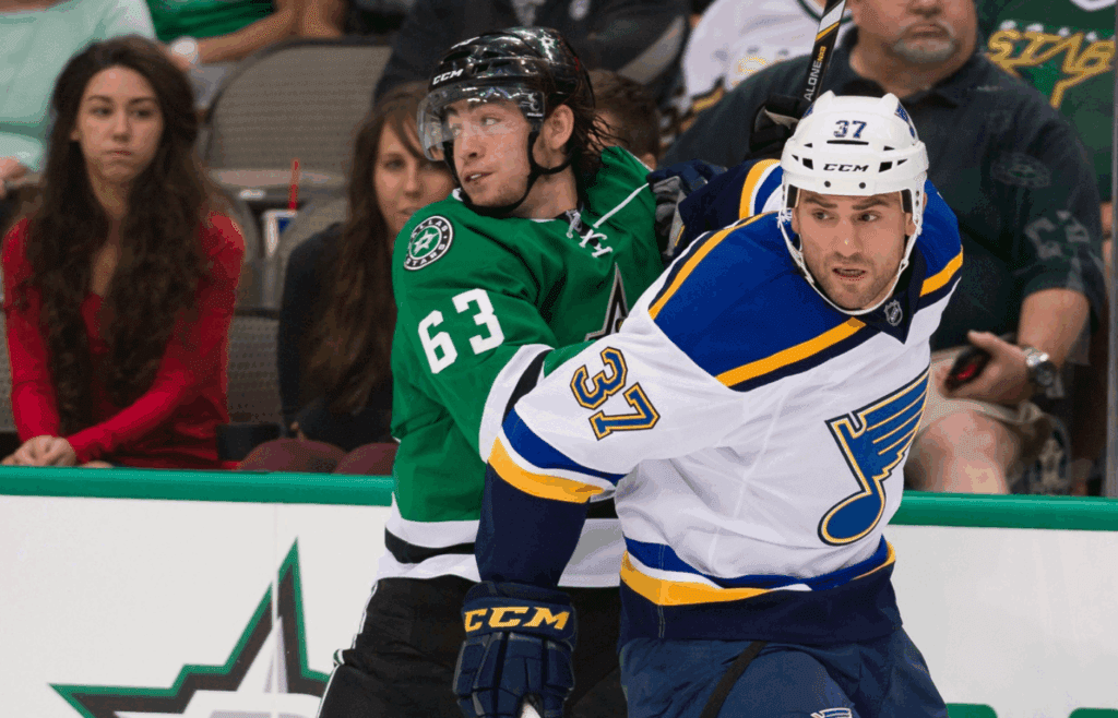 Sep 22, 2014; Dallas, TX, USA; Dallas Stars left wing Remi Elie (63) and St. Louis Blues left wing Paul Bissonnette (37) chase the puck during the game at the American Airlines Center. The Stars defeated the Blues 4-3. Mandatory Credit: Jerome Miron-Imagn Images