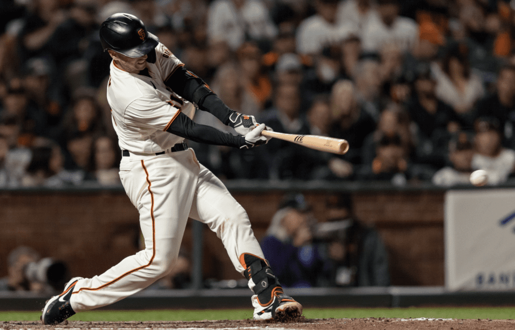 Sep 30, 2021; San Francisco, California, USA; San Francisco Giants catcher Buster Posey (28) hits an RBI double against the Arizona Diamondbacks in the fifth inning at Oracle Park. Mandatory Credit: John Hefti-Imagn Images