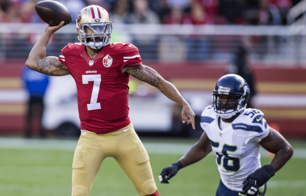 Jan 1, 2017; Santa Clara, CA, USA; San Francisco 49ers quarterback Colin Kaepernick (7) passes the football while being rushed by Seattle Seahawks defensive end Cliff Avril (56) during the first quarter at Levis Stadium. Mandatory Credit: Neville E. Guard-Imagn Images