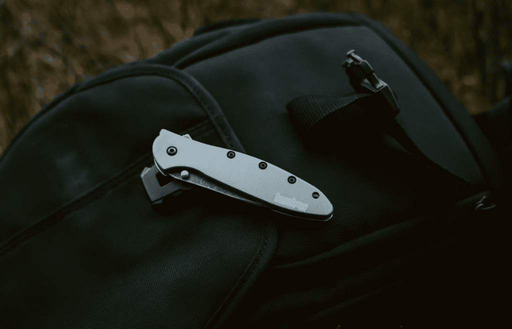 A black pocket knife on a black bag