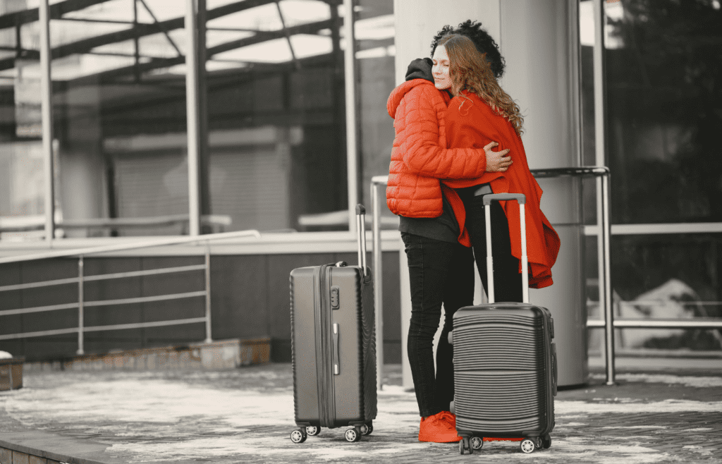 Couple hugs goodbye at airport departure gate