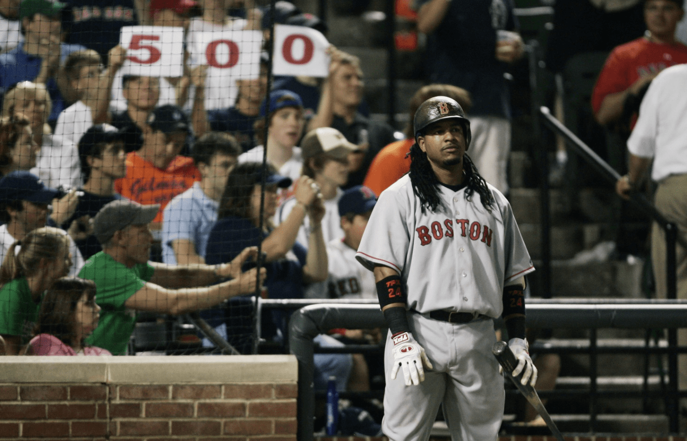 May 31, 2008; Baltimore, MD, USA; Boston Red Sox left fielder Manny Ramirez (24) waits on deck in the ninth inning as fans hold up a "500" sign acknowledging Ramirez' 500th home run which he he in the seventh inning off Baltimore Orioles pitcher Chad Bradford (not pictured) at Camden Yards. Boston won 6-3. Mandatory Credit: James Lang-Imagn Images