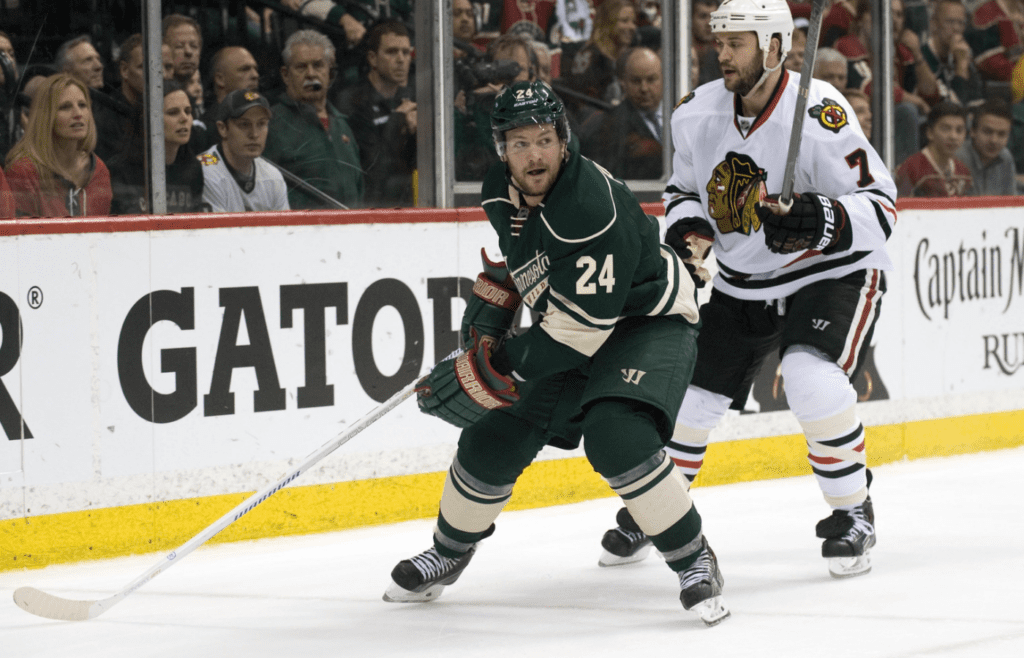 May 7, 2015; Saint Paul, MN, USA; Chicago Blackhawks defenseman Brent Seabrook (7) chases Minnesota Wild forward Matt Cooke (24) behind the Blackhawks net during the second period in game four of the second round of the 2015 Stanley Cup Playoffs at Xcel Energy Center. The Blackhawks defeated the Wild 4-3 sweeping the second round of playoffs. Mandatory Credit: Marilyn Indahl-Imagn Images