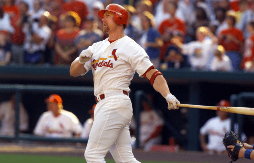 Mark McGwire watches homer number 67 clear the fence against Montreal on Sept. 26, 1998 to reclaim the season record from Chicago's Sammy Sosa.
