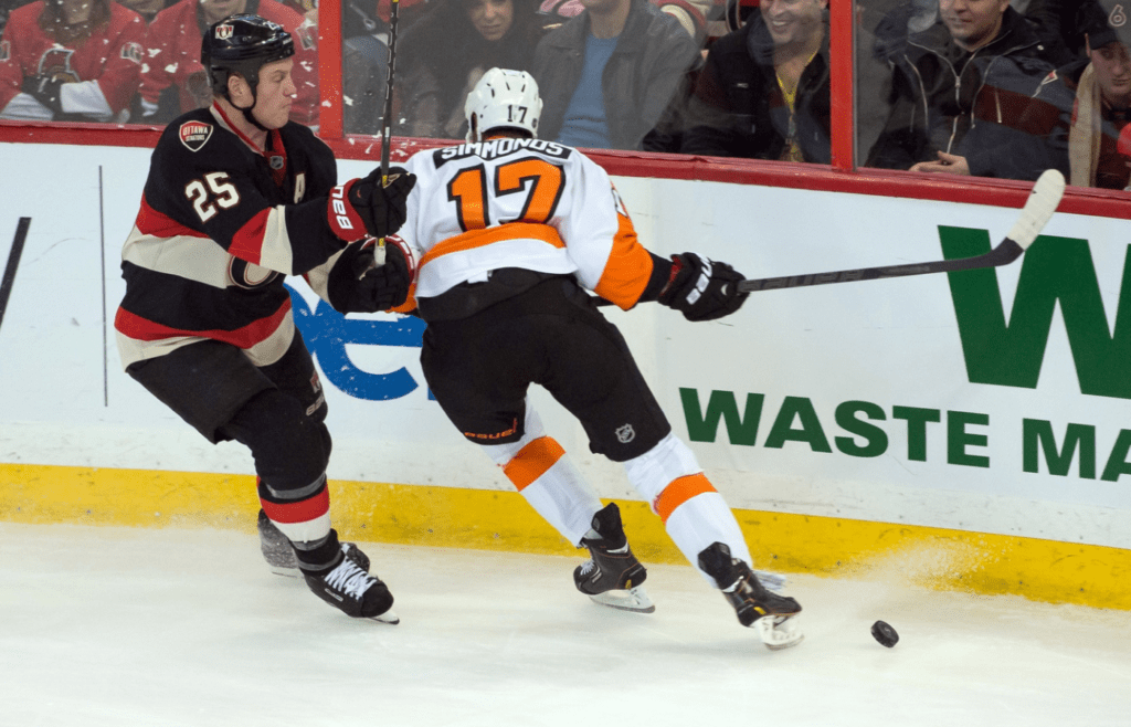 Dec 9, 2013; Ottawa, Ontario, CAN; Philadelphia Flyers right wing Wayne Simmonds (17) is checked by Ottawa Senators right wing Chris Neil (25) in the third period at the Canadian Tire Centre.The Senators defeated the Flyers 5-4 in a shoot-out. Mandatory Credit: Marc DesRosiers-Imagn Images