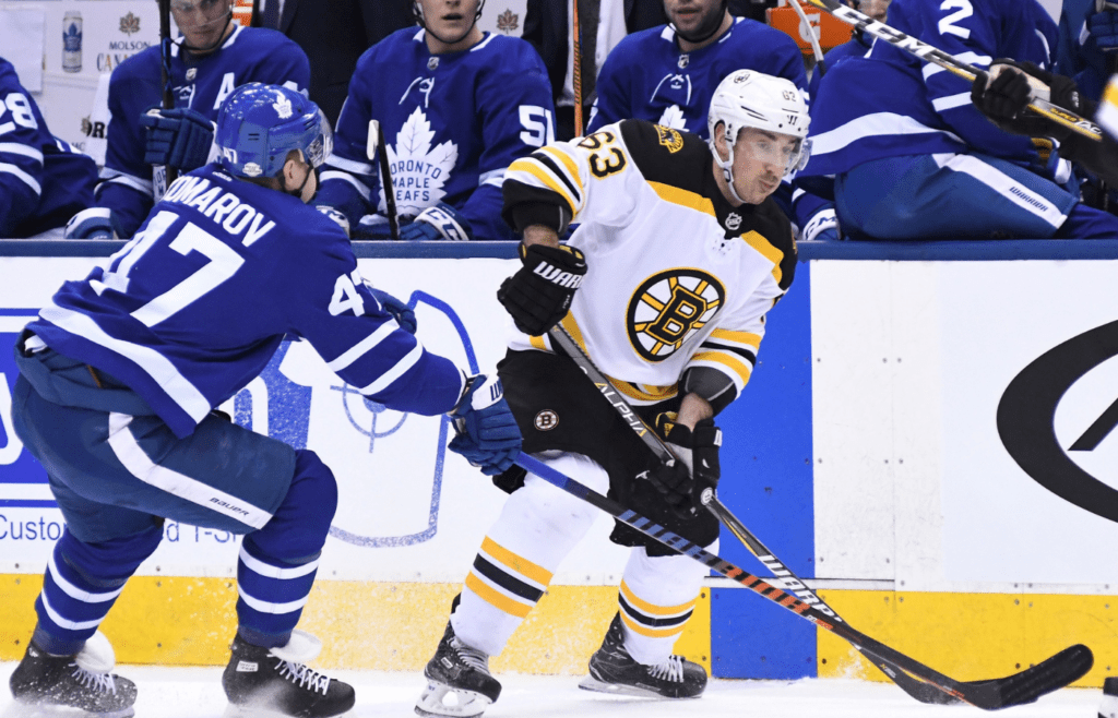 Feb 24, 2018; Toronto, Ontario, CAN; Boston Bruins forward Brad Marchand (63) skates the puck past Toronto Maple Leafs forward Leo Komarov (47) in the first period at Air Canada Centre. Mandatory Credit: Dan Hamilton-Imagn Images