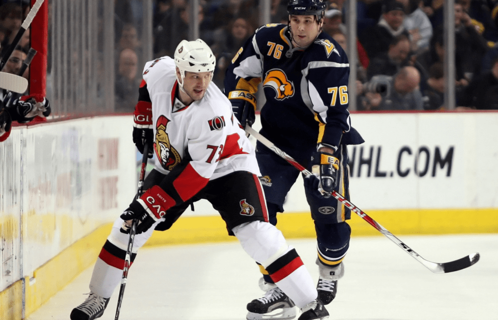 Jan 6, 2009; Buffalo, NY, USA; Ottawa Senators left wing Jarkko Ruutu (73) looks back as Buffalo Sabres left wing Andrew Peters (76) moves in for a check at the HSBC Arena. Mandatory Credit: Kevin Hoffman-Imagn Images
