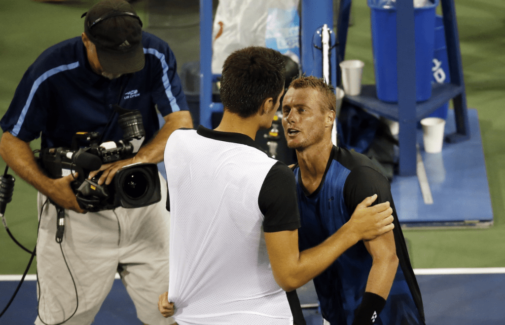 Sep 3, 2015; New York, NY, USA; Lleyton Hewitt of Australia (R) hugs Bernard Tomic of Australia (L) after their match on day four of the 2015 U.S. Open tennis tournament at USTA Billie Jean King National Tennis Center. Tomic won 6-3, 6-2, 3-6, 5-7, 7-5. Mandatory Credit: Geoff Burke-Imagn Images