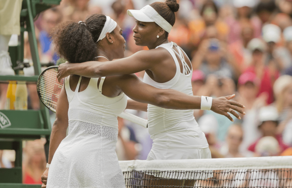 Jul 6, 2015; London, United Kingdom; Serena Williams (USA) and Venus Williams (USA) hug at the net after their match on day seven of The Championships Wimbledon at the AELTC. Mandatory Credit: Susan Mullane-Imagn Images