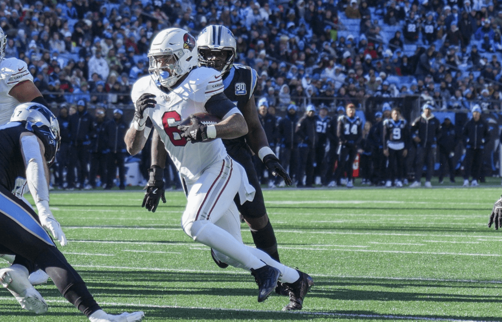 Dec 22, 2024; Charlotte, North Carolina, USA; Arizona Cardinals running back James Conner (6) runs for a touchdown score against the Carolina Panthers during the second quarter at Bank of America Stadium. Mandatory Credit: Jim Dedmon-Imagn Images