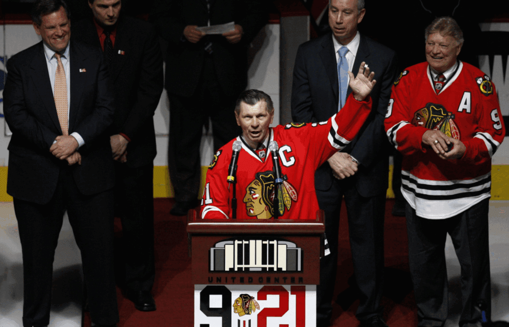 March 7, 2008; Chicago, IL, USA; Chicago Blackhawks former player Stan Mikita (21) addresses the crowd as he stands in front of fellow former player Bobby Hull (9) and team officials during a ceremony honoring their careers before the game against the San Jose Sharks at the United Center. Mandatory Credit: Jerry Lai-Imagn Images