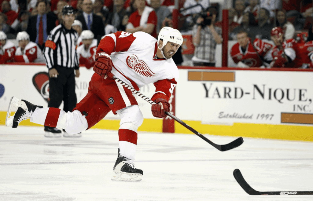 April 6, 2011; Raleigh, NC, USA; Detroit Red Wings center Mike Modano (90) takes a shot against the Carolina Hurricanes at the RBC center. The Hurricanes defeated the Red Wings 3-0. Mandatory Credit: James Guillory-Imagn Images