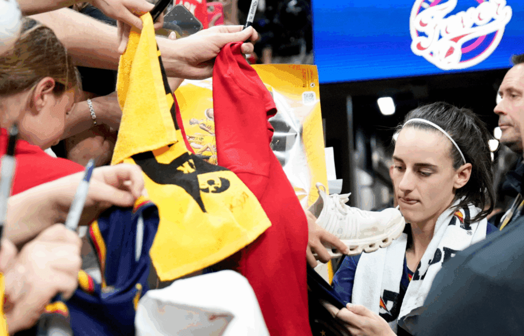 Indiana Fever guard Caitlin Clark (22) signs autographs for fans after the Fever defeated Brazil in a preseason game May 4, 2025 at Carver-Hawkeye Arena in Iowa City, Iowa